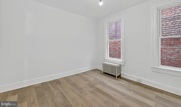 an empty room with wooden floor