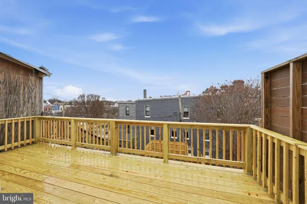 a view of a balcony with wooden floor and city view