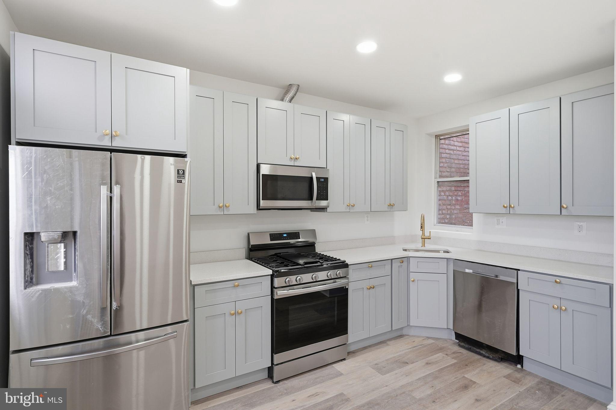 2032 North Capitol Street Northwest, Unit 2 Washington, DC 20002 - Photo 2 of 19 a kitchen with white cabinets and white appliances