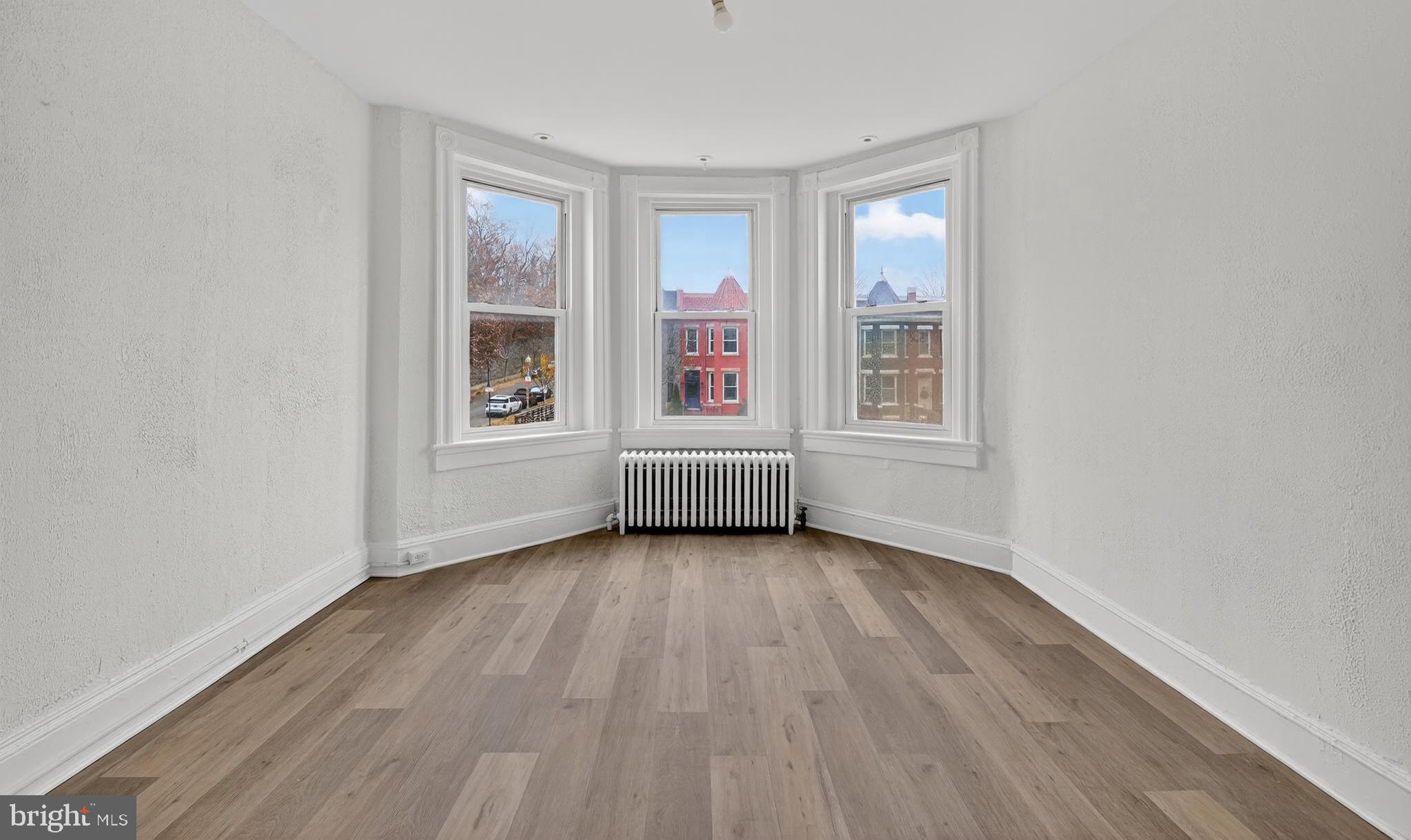 2032 North Capitol Street Northwest, Unit 2 Washington, DC 20002 - Photo 5 of 19 a view of an empty room with wooden floor and a window