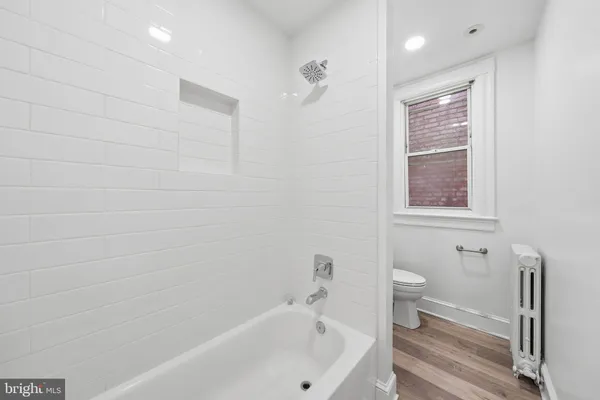 a bathroom with a bathtub and a toilet