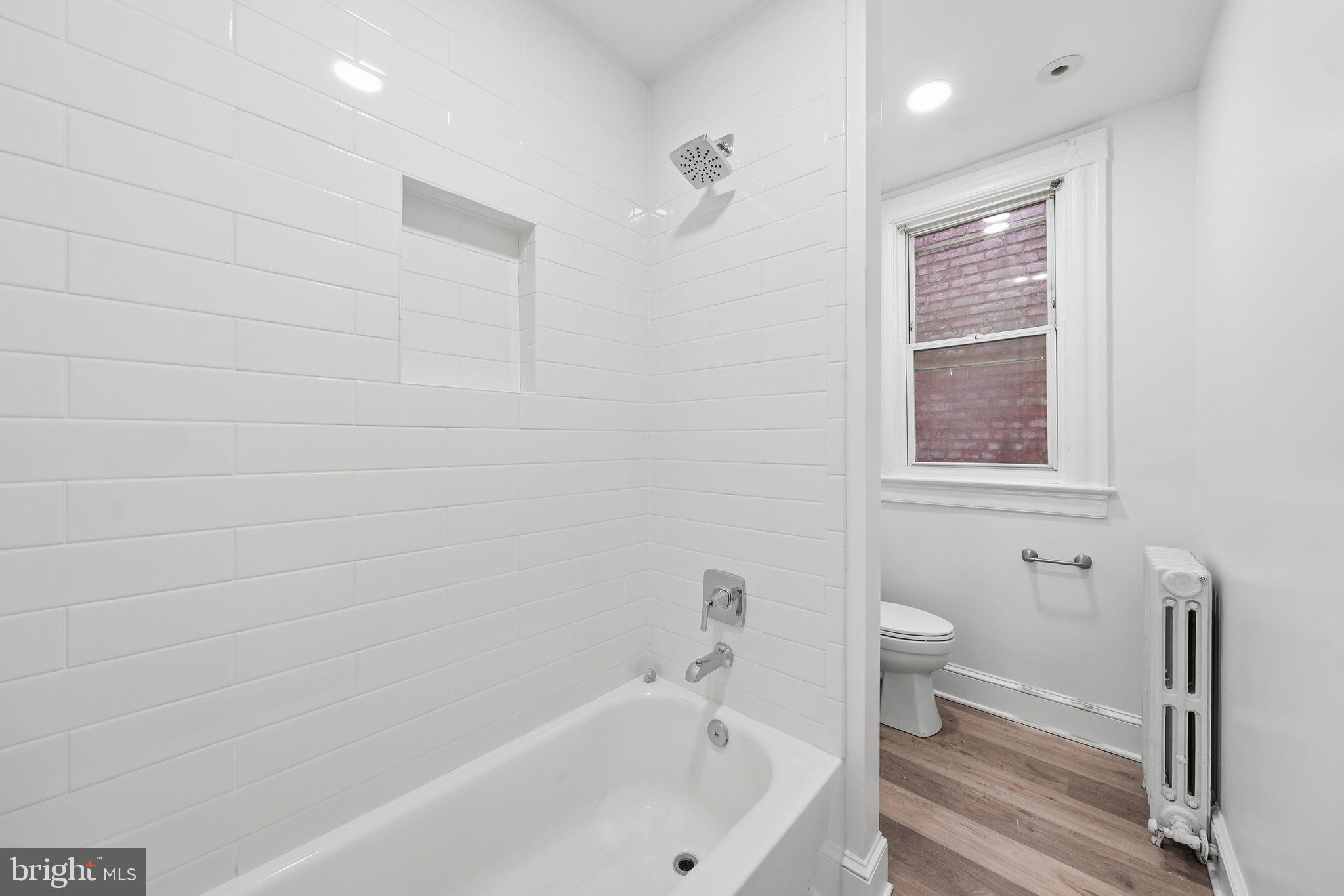 2032 North Capitol Street Northwest, Unit 2 Washington, DC 20002 - Photo 8 of 19 a bathroom with a bathtub and a toilet