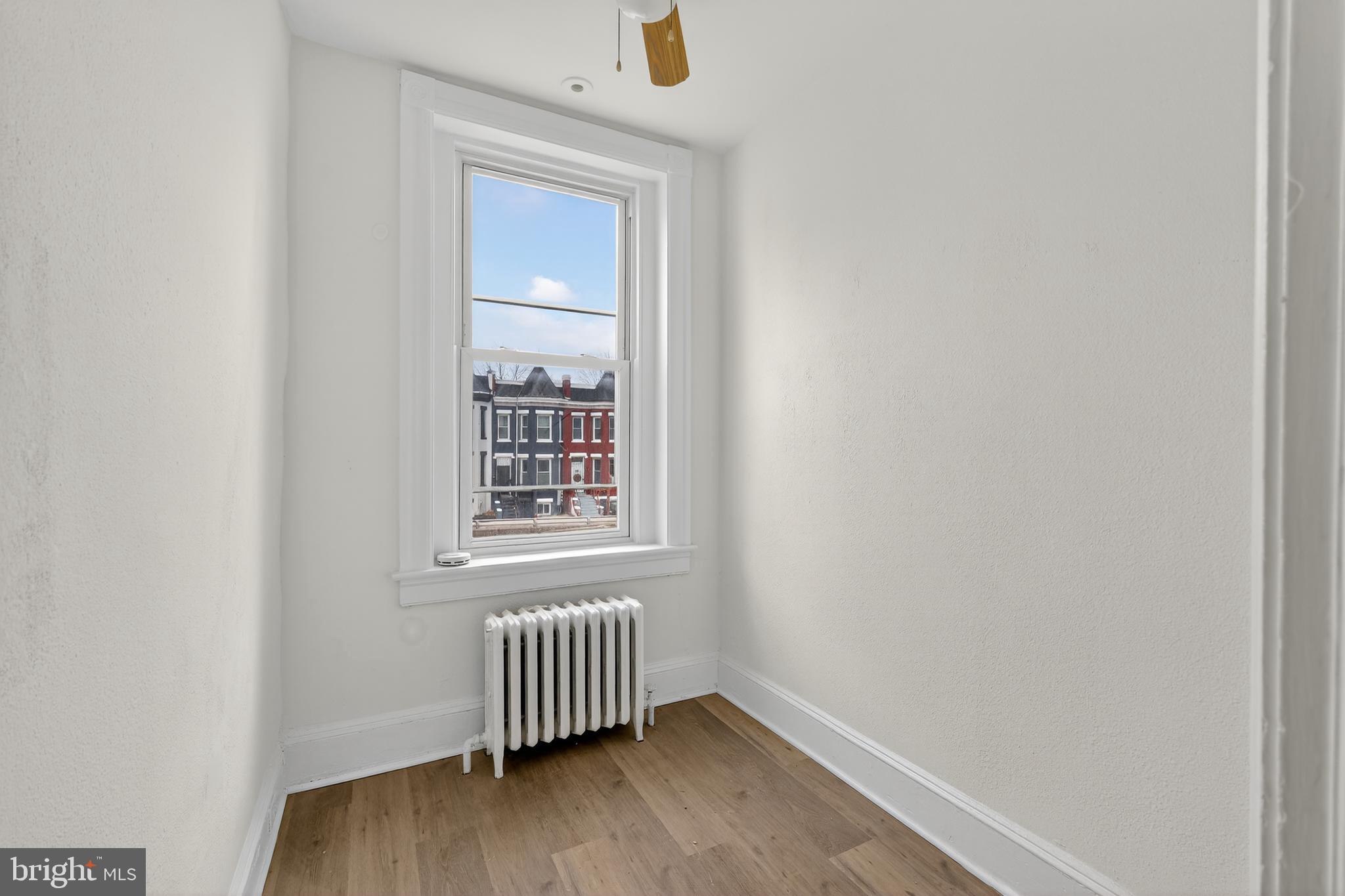 2032 North Capitol Street Northwest, Unit 2 Washington, DC 20002 - Photo 10 of 19 an empty room with wooden floor and windows