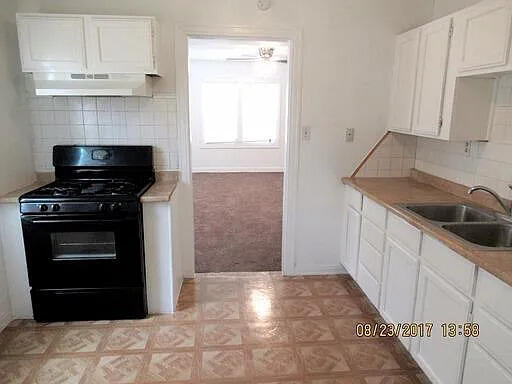 2023 37th Street Lubbock, TX 79412 - Photo 2 of 5 a kitchen with granite countertop a stove and a refrigerator
