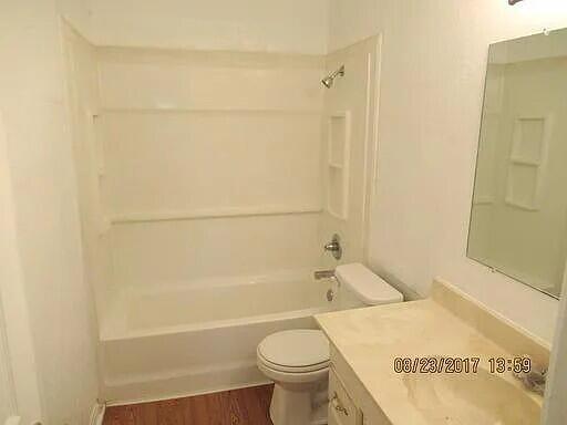 2023 37th Street Lubbock, TX 79412 - Photo 4 of 5 a bathroom with a bathtub and a toilet