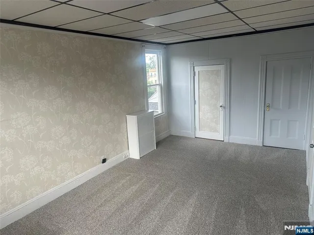 a view of an empty room with a fireplace