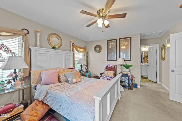 a bedroom with a bed a window and a chandelier