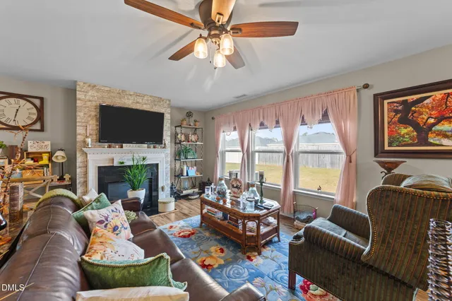 a living room with fireplace furniture and a flat screen tv