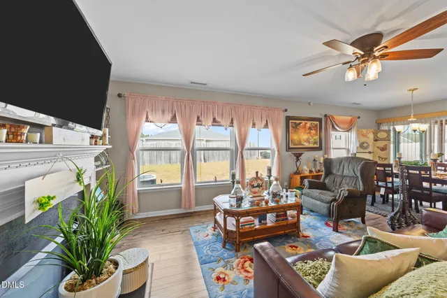 a living room with patio furniture and a potted plant