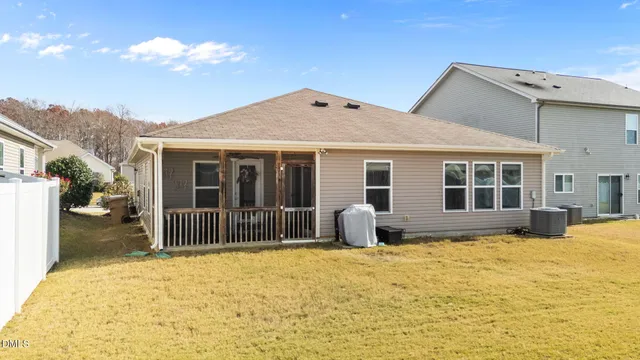 a house view with swimming pool in front of it