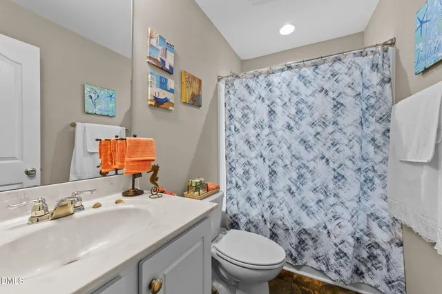a bathroom with a sink toilet and mirror