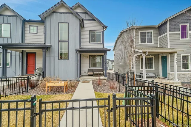 a view of a brick house with large windows