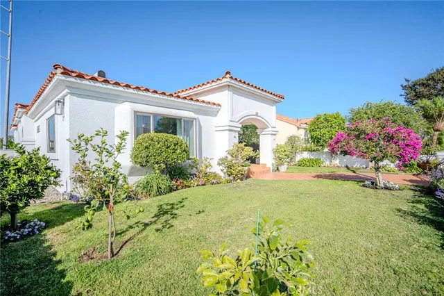 a front view of a house with a garden