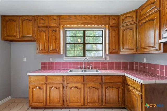 a kitchen with stainless steel appliances granite countertop a sink and cabinets