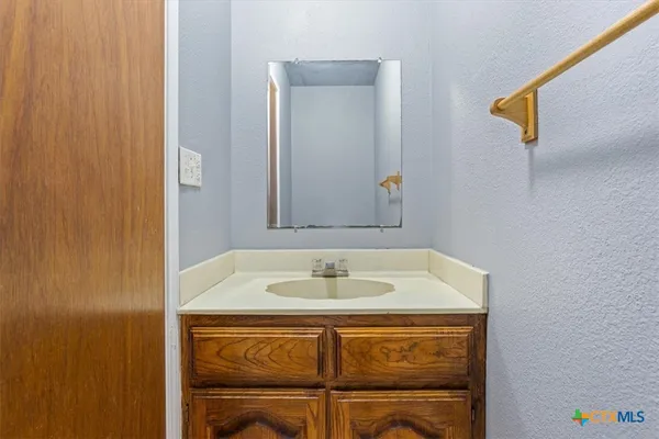 a bathroom with a sink and a mirror