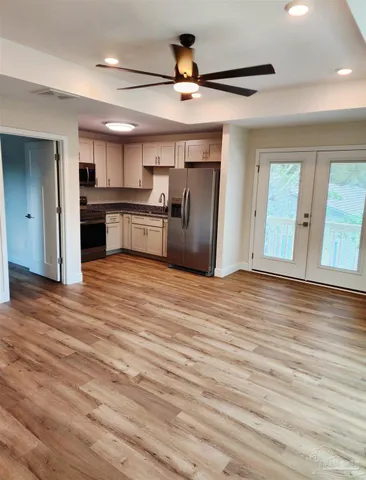 a view of kitchen with refrigerator microwave and stove