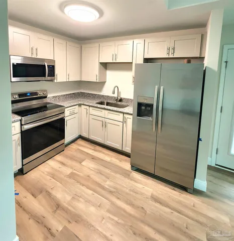 a kitchen with a refrigerator sink and microwave