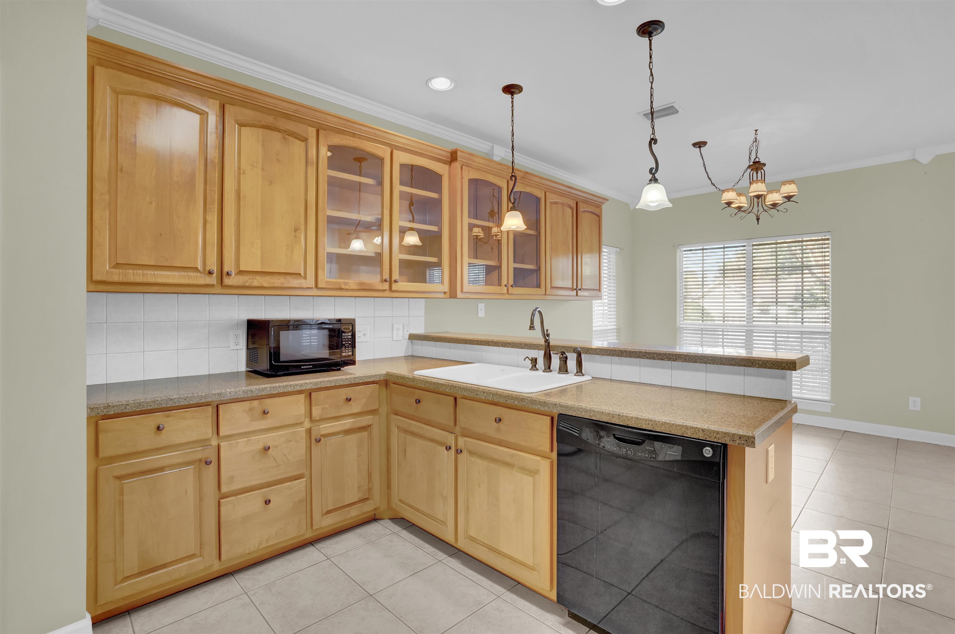 100 Conti Court Fairhope, AL 36532 - Photo 23 of 54 Kitchen with kitchen peninsula, sink, ornamental molding, and black appliances