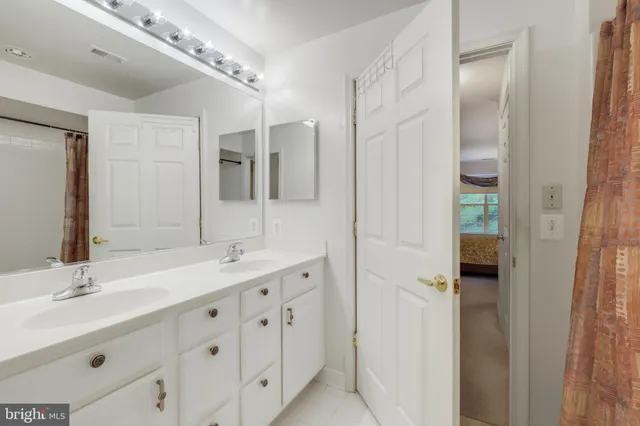 a bathroom with a double vanity sink and mirror