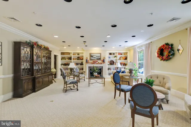 a dining room with furniture and kitchen view