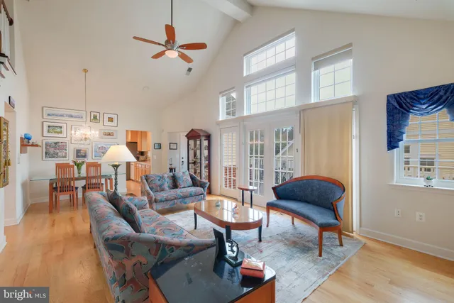 a living room with furniture a rug and a chandelier