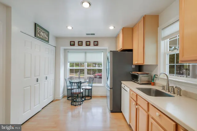 a kitchen with stainless steel appliances granite countertop a refrigerator and a sink