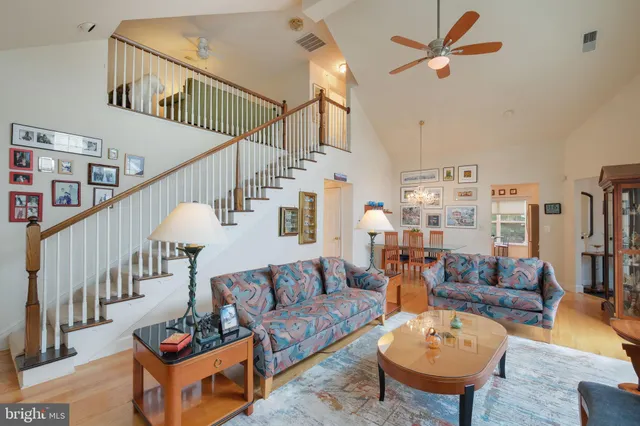 a living room with furniture and a chandelier