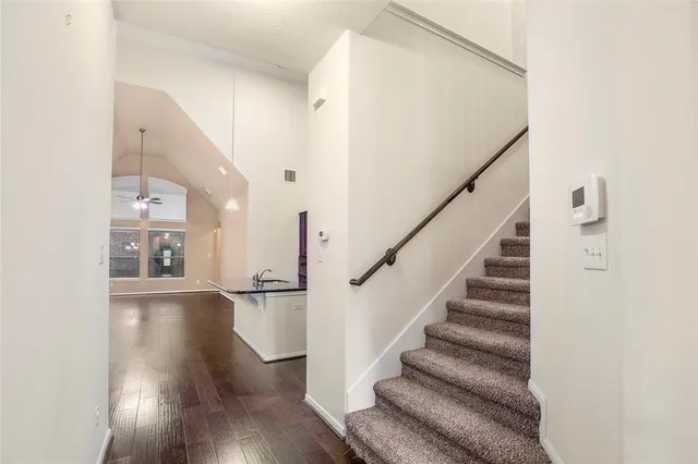 a view of entryway and hall with wooden floor