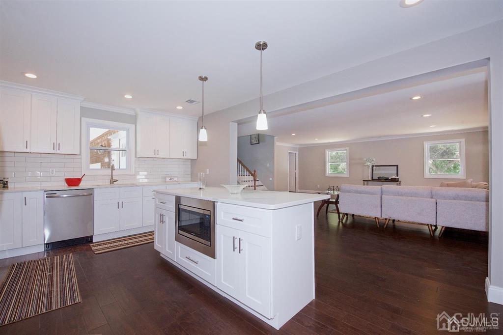 12 Cottrell Road Matawan, NJ 07747 - Photo 13 of 38 a kitchen with a sink and wooden floor
