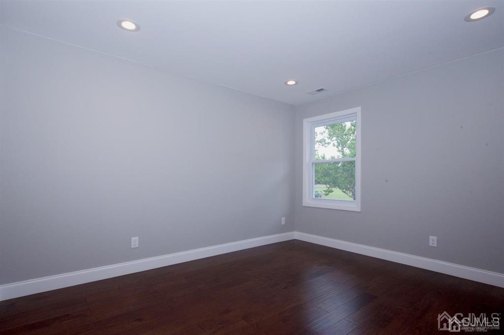 12 Cottrell Road Matawan, NJ 07747 - Photo 20 of 38 an empty room with wooden floor and windows