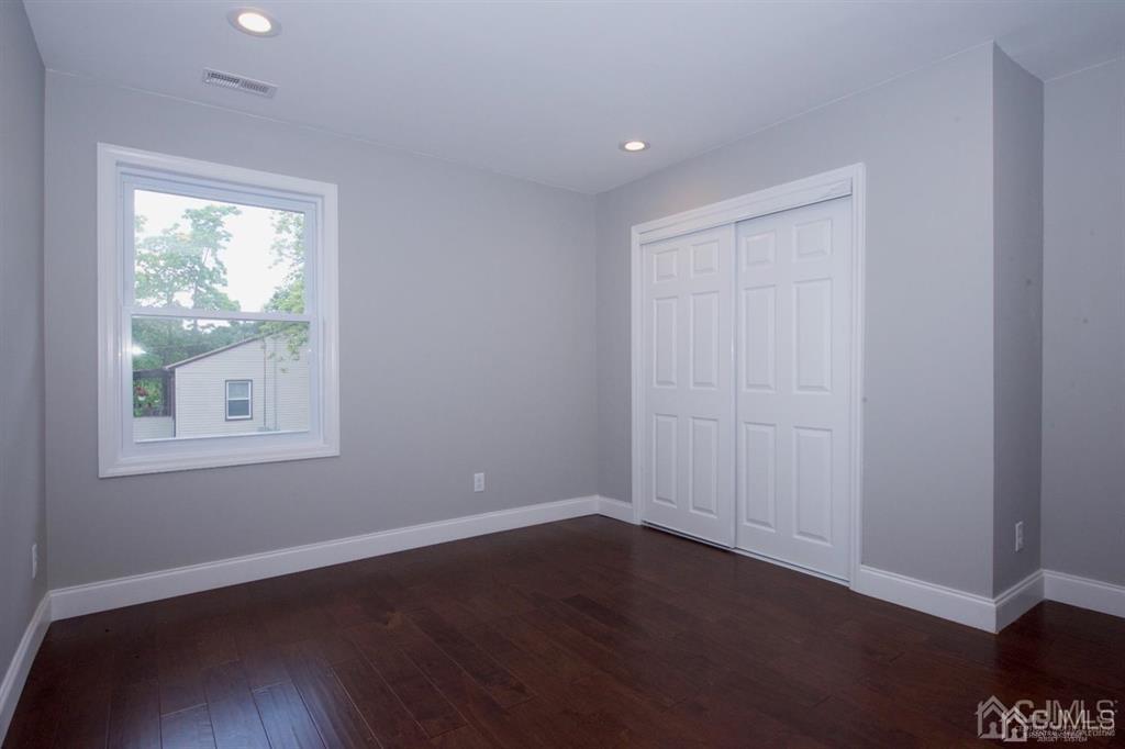 12 Cottrell Road Matawan, NJ 07747 - Photo 21 of 38 an empty room with wooden floor and windows
