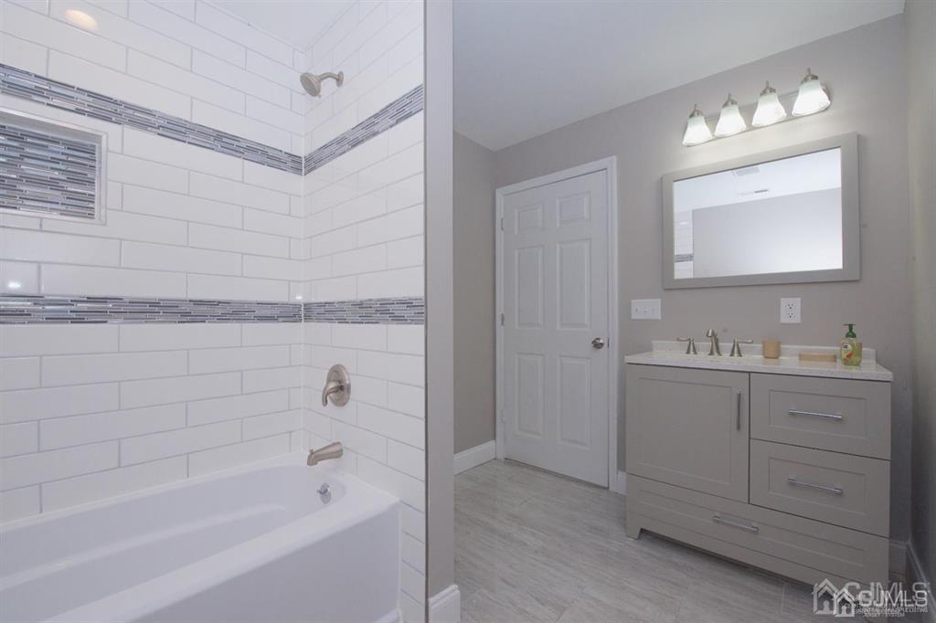 12 Cottrell Road Matawan, NJ 07747 - Photo 26 of 38 a bathroom with a bathtub and a sink