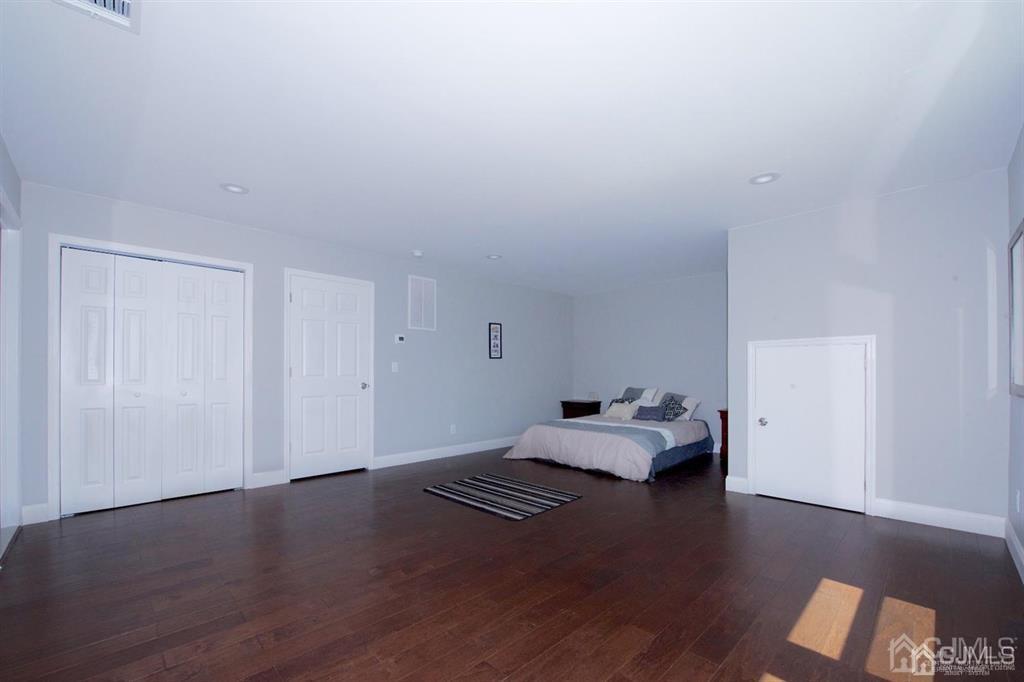 12 Cottrell Road Matawan, NJ 07747 - Photo 29 of 38 a room with a bed and wooden floor