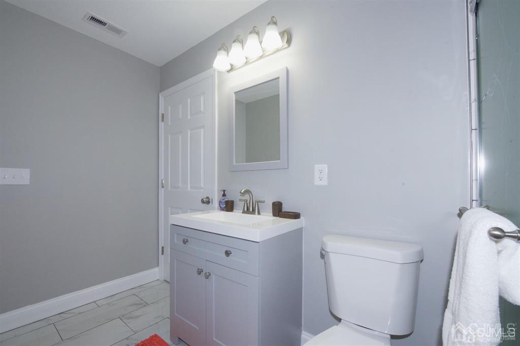12 Cottrell Road Matawan, NJ 07747 - Photo 31 of 38 a bathroom with a sink toilet vanity and mirror