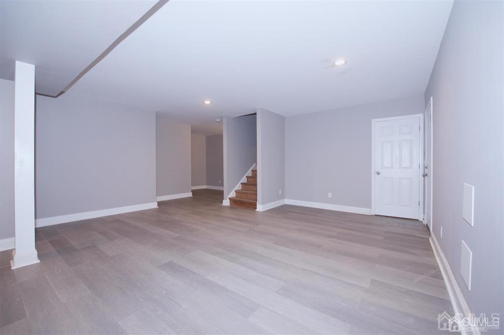 12 Cottrell Road Matawan, NJ 07747 - Photo 33 of 38 a view of an empty room with wooden floor and window