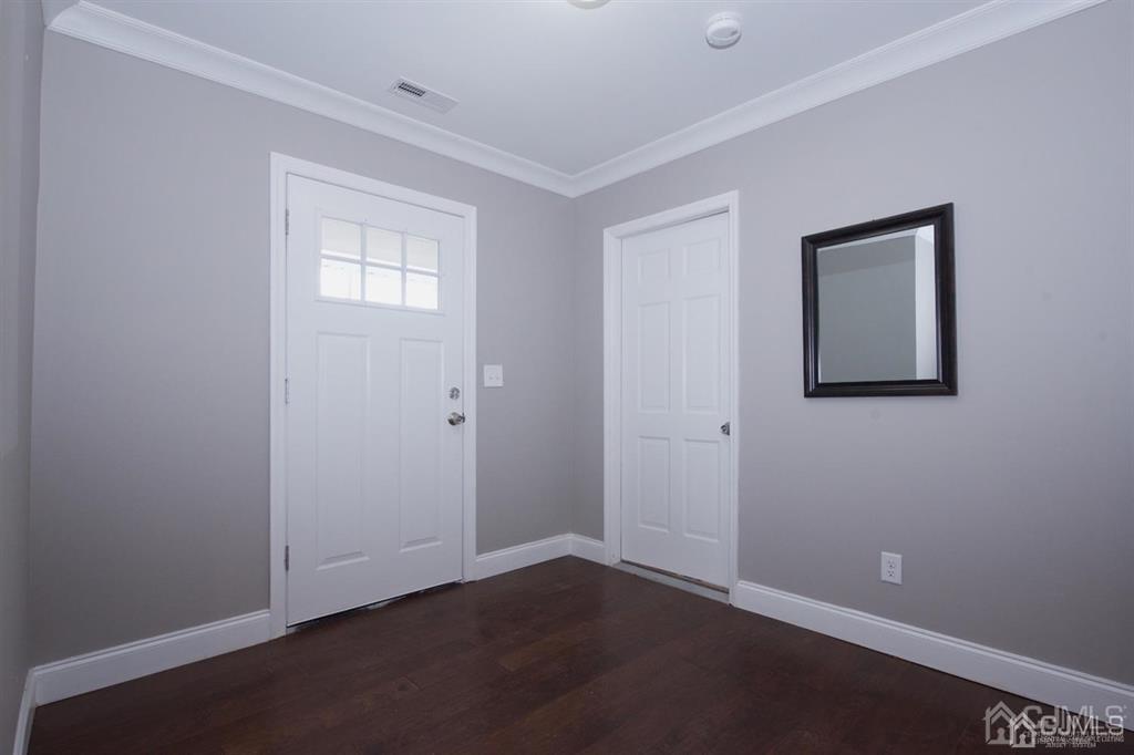 12 Cottrell Road Matawan, NJ 07747 - Photo 5 of 38 a view of an empty room with wooden floor and a window