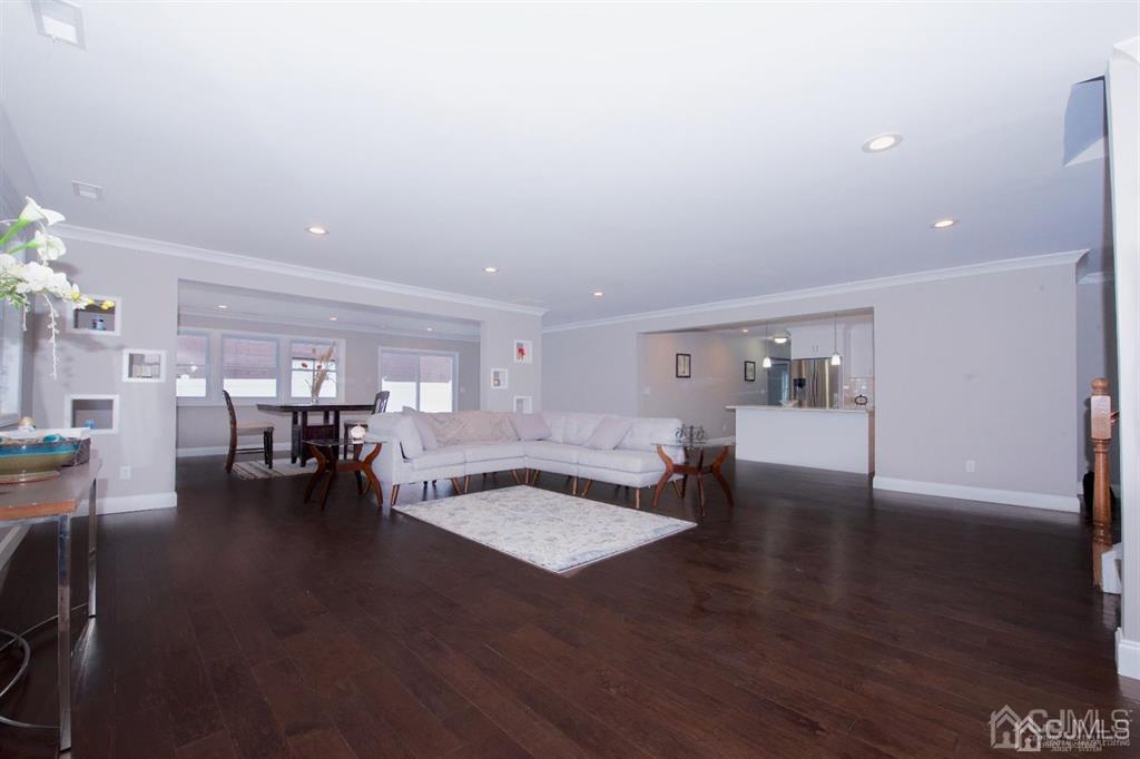12 Cottrell Road Matawan, NJ 07747 - Photo 7 of 38 a living room with couches and a dining table with wooden floor