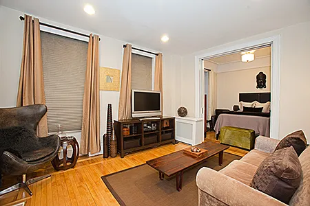 a living room with furniture gym equipment and a flat screen tv