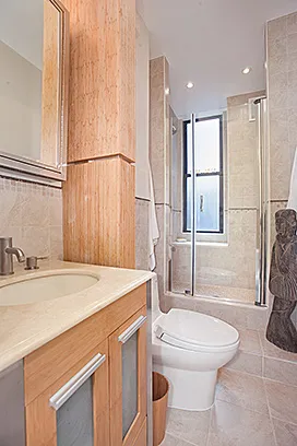 a bathroom with a sink toilet and shower