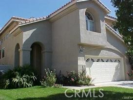 31114 Ruidosa Street Temecula, CA 92592 - Photo 1 of 1 a front view of a house with a garden