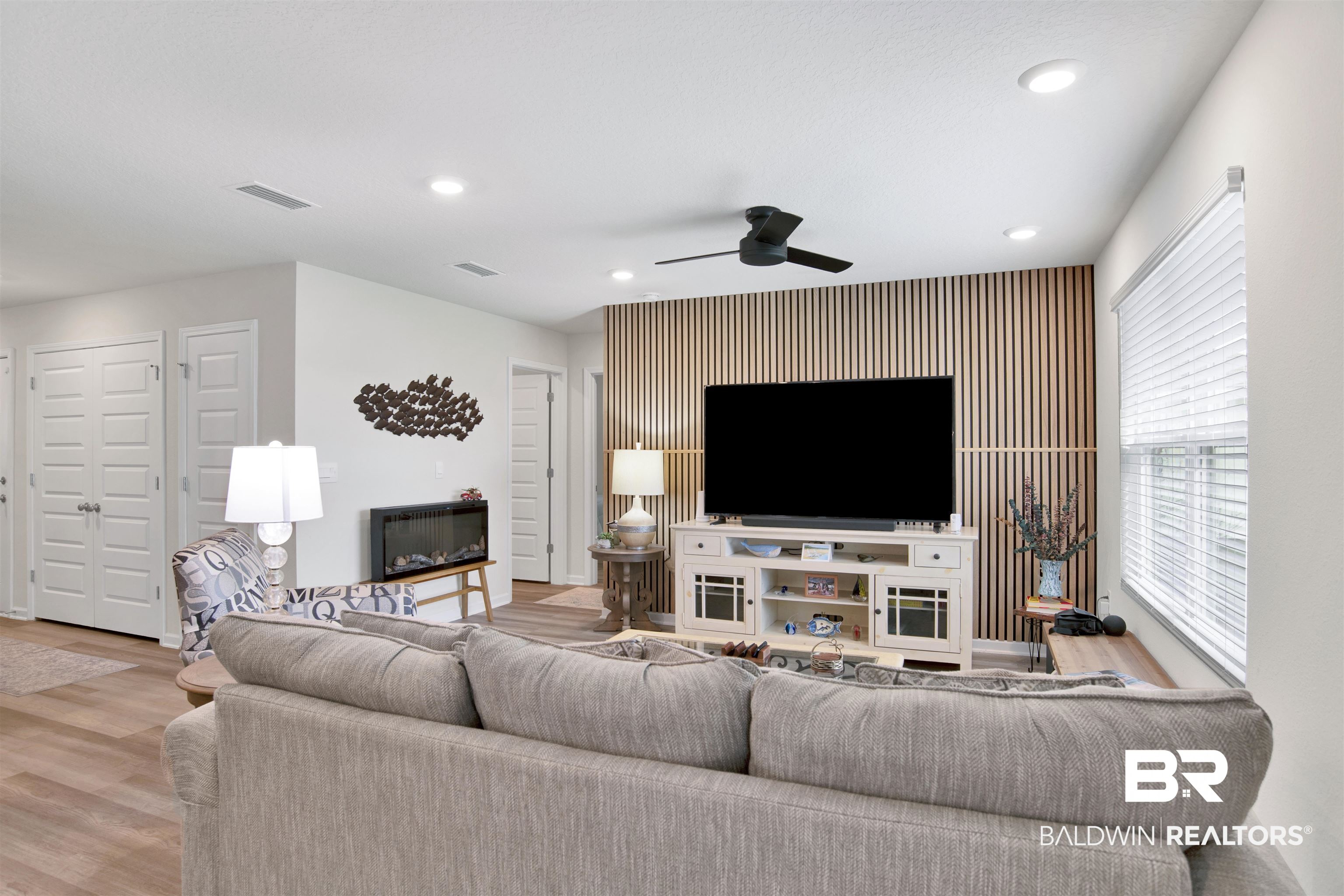 22348 Aleutian Avenue Foley, AL 36535 - Photo 7 of 32 Living room featuring ceiling fan, recessed lighting, wood finished floors, and an accent wall
