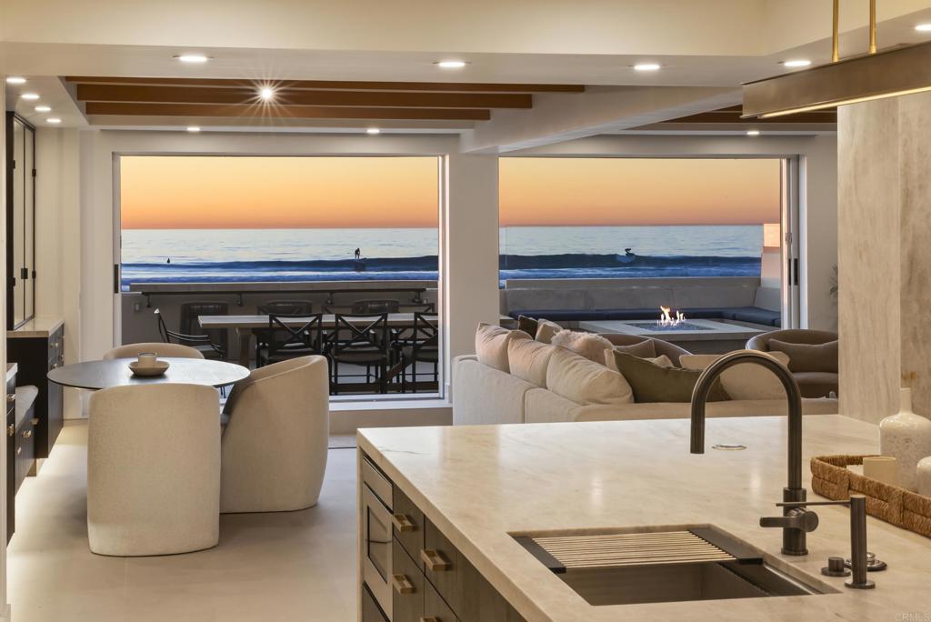 2016 Ocean Front Del Mar, CA 92014 - Photo 2 of 12 a living room with furniture a flat screen tv and a floor to ceiling window