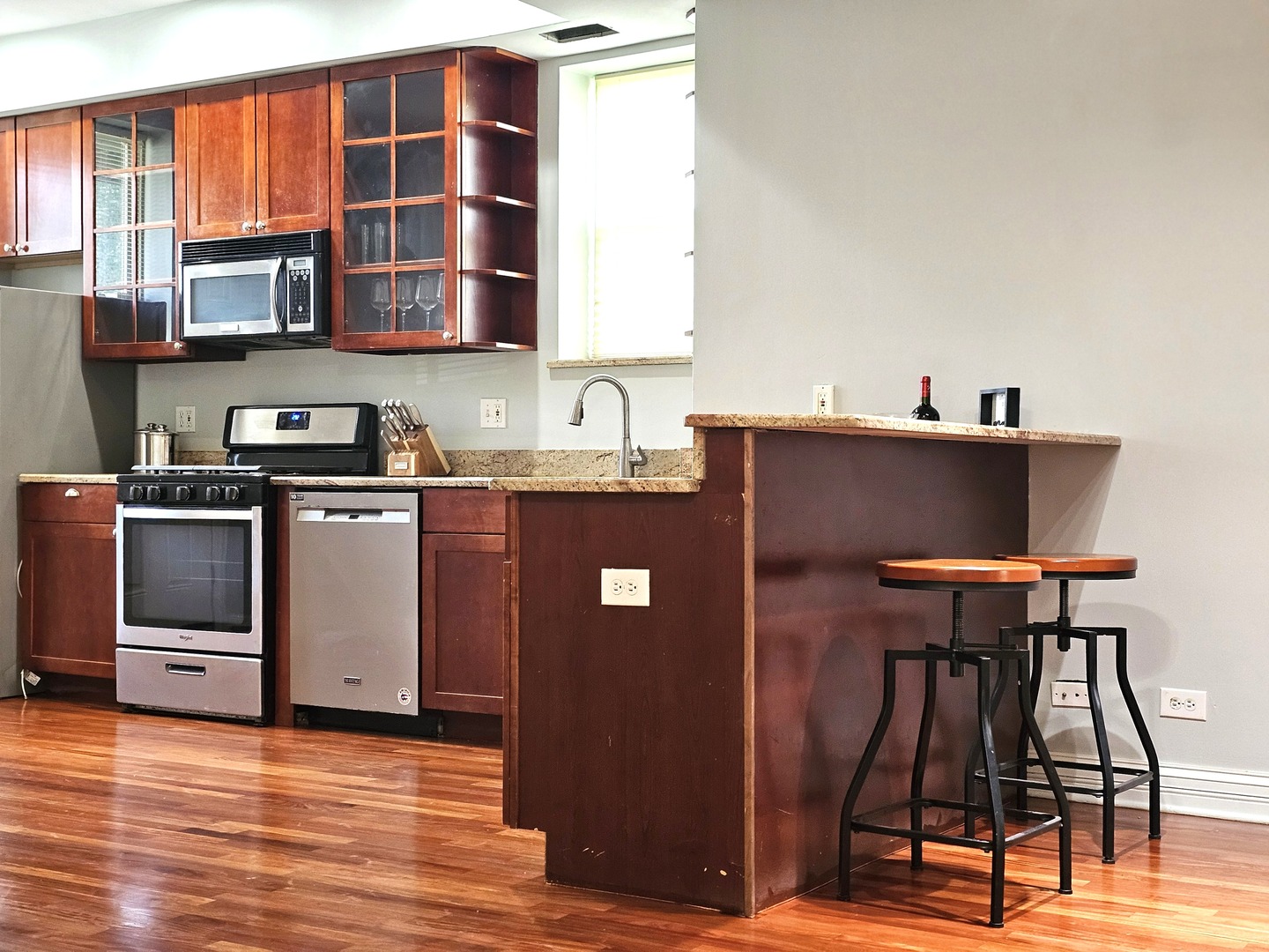 1520 East Marquette Road, Unit 2B Chicago, IL 60637 - Photo 12 of 44 a kitchen with stainless steel appliances granite countertop a stove a sink dishwasher and a refrigerator with wooden floor