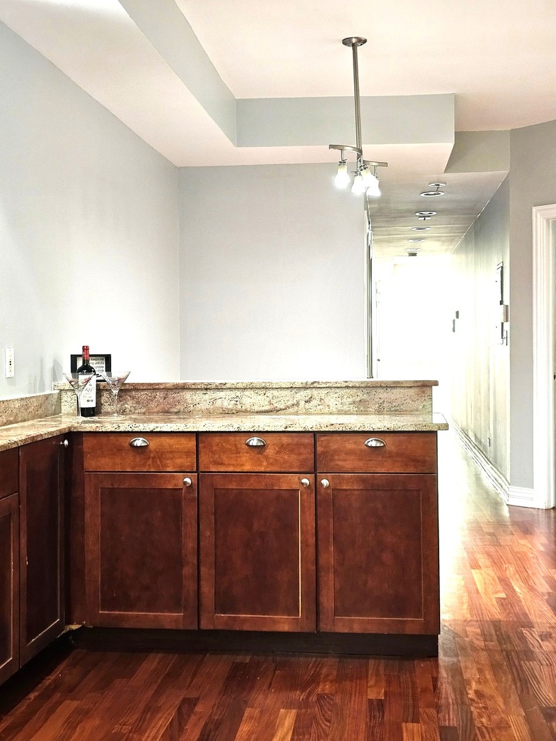 1520 East Marquette Road, Unit 2B Chicago, IL 60637 - Photo 15 of 44 a view of a kitchen with a sink and wooden floor