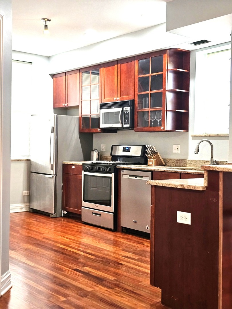 1520 East Marquette Road, Unit 2B Chicago, IL 60637 - Photo 16 of 44 a kitchen with stainless steel appliances granite countertop a stove a sink and a refrigerator