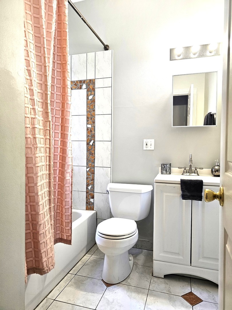 1520 East Marquette Road, Unit 2B Chicago, IL 60637 - Photo 39 of 44 a white toilet sitting next to a bathroom sink