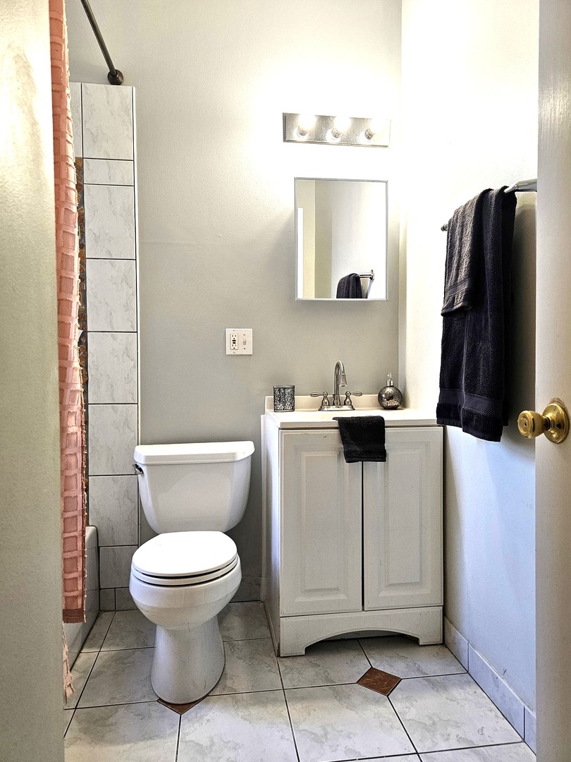 1520 East Marquette Road, Unit 2B Chicago, IL 60637 - Photo 40 of 44 a white toilet sitting next to a bathroom sink