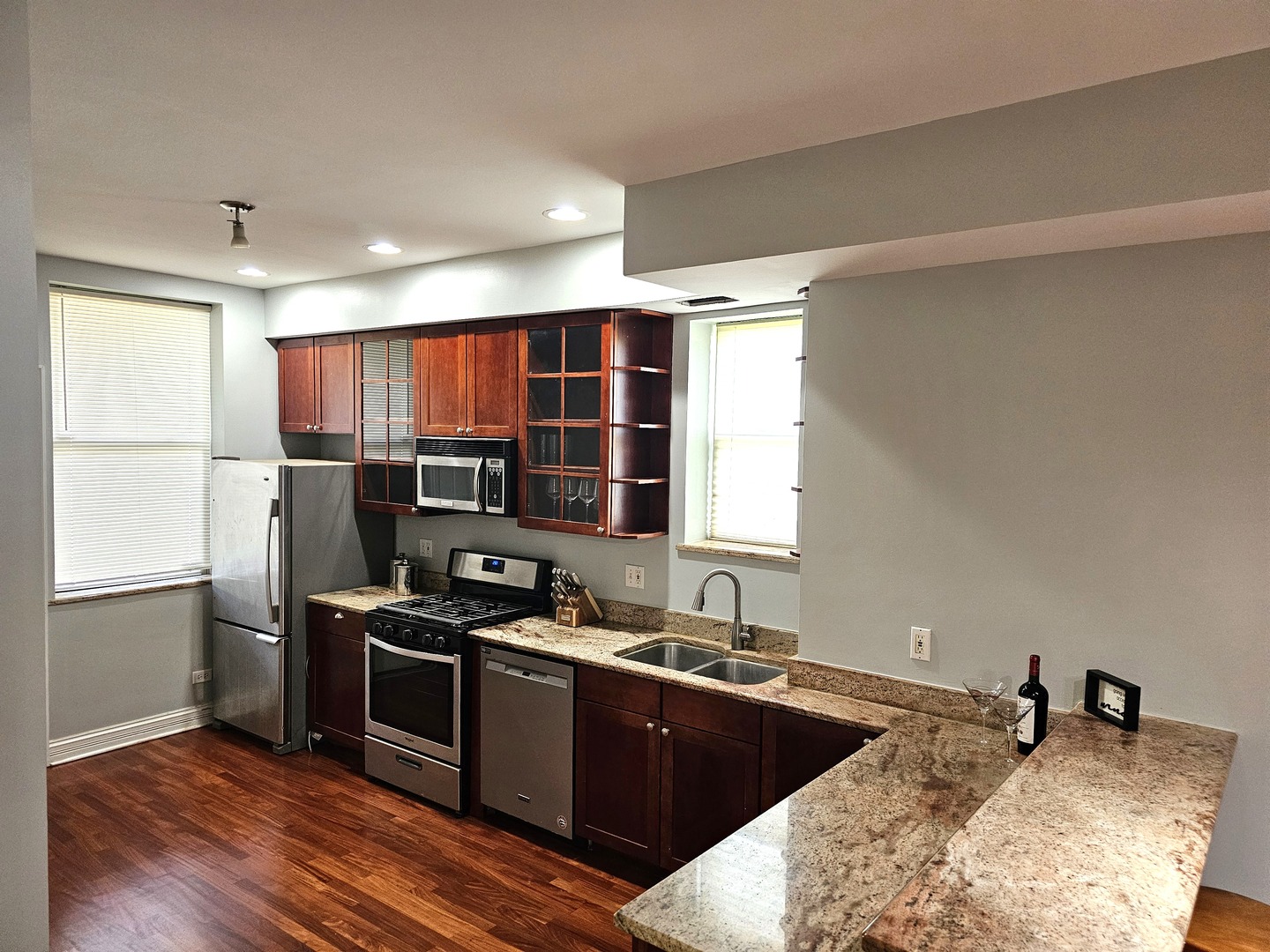 1520 East Marquette Road, Unit 2B Chicago, IL 60637 - Photo 7 of 44 a kitchen with stainless steel appliances granite countertop a stove a sink and a refrigerator