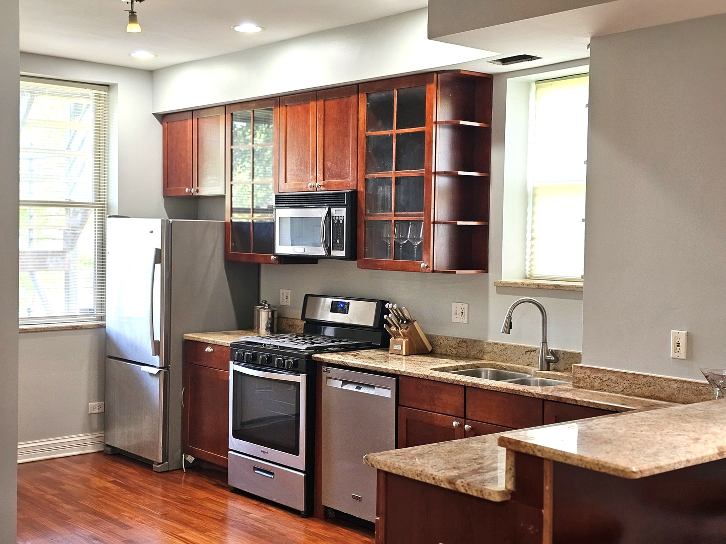 1520 East Marquette Road, Unit 2B Chicago, IL 60637 - Photo 9 of 44 a kitchen with stainless steel appliances a sink a stove a refrigerator cabinets and a window