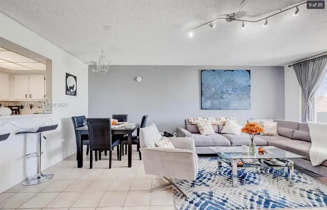 a living room with furniture a rug and a chandelier